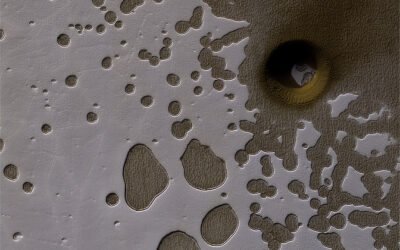 Mars Has Bizarre “Swiss Cheese” Terrain. You can Thank Water, Carbon Dioxide and 500,000 years of Climate History for That