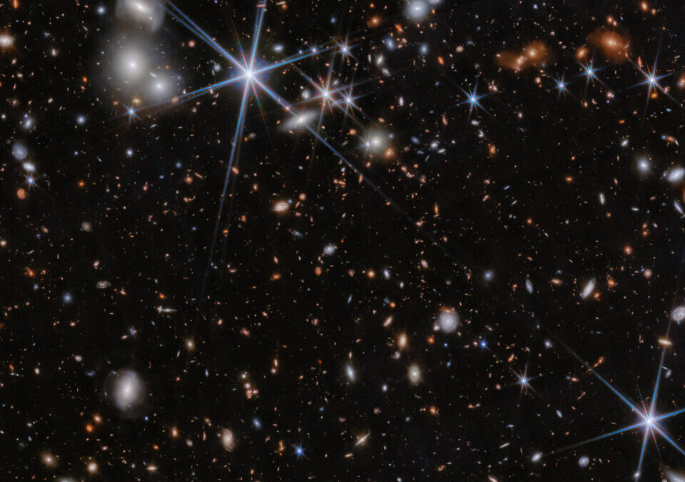 JWST discovers black holes merging near the dawn of the cosmos